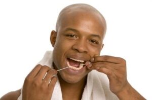A man flossing his teeth to prevent gum disease in Casper.